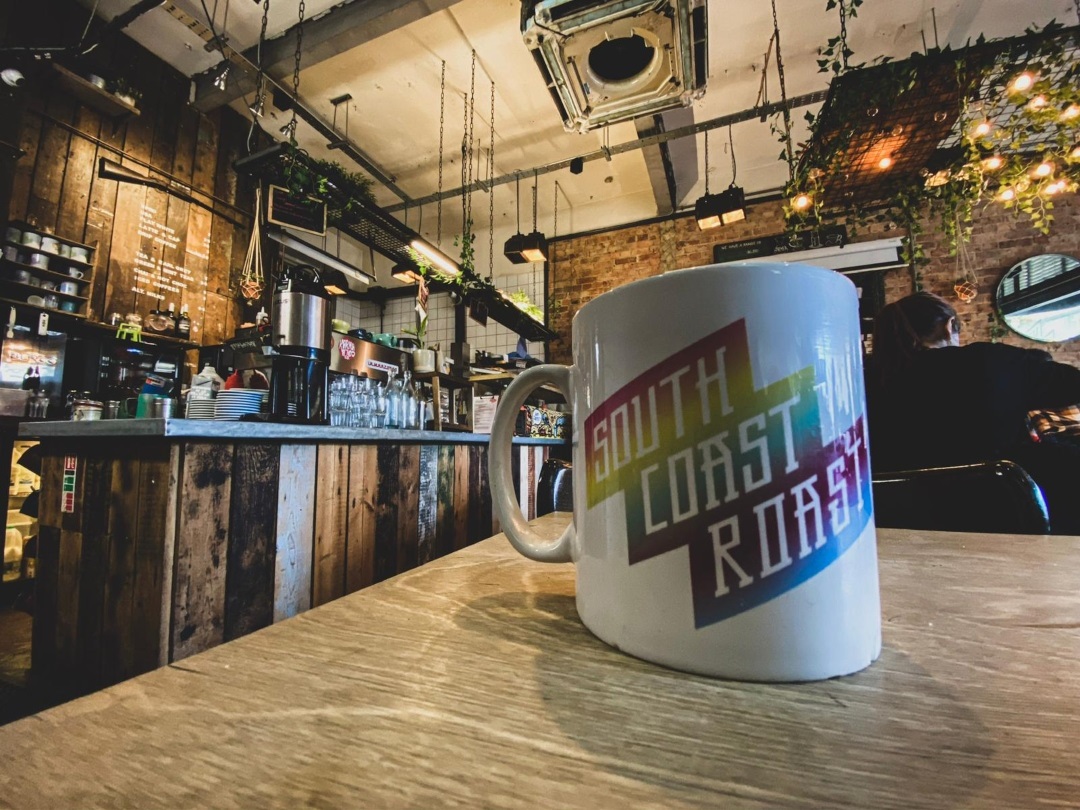 A close-up shot of a South Coast Roast branded mug in Bournemouth